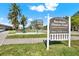 Bayshore Fitness Trail sign with palm trees and exercise equipment under a blue sky at 1301 S Howard Ave # B24, Tampa, FL 33606