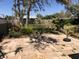 Spacious stone backyard patio surrounded by lush landscaping at 1465 Fundy Rd, Venice, FL 34293
