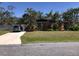 Charming single-story home with a well-manicured lawn, mature trees and a private driveway at 1465 Fundy Rd, Venice, FL 34293