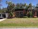 Charming single-story home with a well-manicured lawn, mature trees and a private driveway at 1465 Fundy Rd, Venice, FL 34293