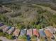 The aerial view displays a row of houses with a pond and a highway in the background at 15925 Pond Rush Ct, Land O Lakes, FL 34638