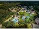 Aerial view of the community amenities, which includes a pool, tennis court, basketball court, and playground at 15925 Pond Rush Ct, Land O Lakes, FL 34638