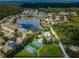 Aerial view shows community with several homes, lakes, tennis courts, basketball courts, and a pool at 15925 Pond Rush Ct, Land O Lakes, FL 34638