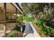 Beautiful backyard featuring a screened-in patio, stone pathway, and lush landscaping at 15925 Pond Rush Ct, Land O Lakes, FL 34638