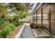 Beautiful backyard featuring a screened-in patio, stone pathway, and lush landscaping at 15925 Pond Rush Ct, Land O Lakes, FL 34638
