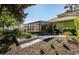 Backyard featuring a screened-in patio and stone walkway with lush landscaping around the property at 15925 Pond Rush Ct, Land O Lakes, FL 34638