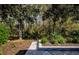 Landscaped backyard featuring mature trees and plants creates a peaceful setting at 15925 Pond Rush Ct, Land O Lakes, FL 34638
