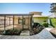 Backyard view showcasing a screened-in patio with lush landscaping and brick pathway at 15925 Pond Rush Ct, Land O Lakes, FL 34638