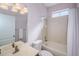 Cozy bathroom features a shower-tub combo, a white vanity, and complementary fixtures at 15925 Pond Rush Ct, Land O Lakes, FL 34638