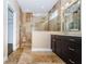 Bathroom boasts a marble-tiled walk-in shower, dark cabinets, and a light countertop at 15925 Pond Rush Ct, Land O Lakes, FL 34638