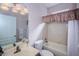 Bathroom features a tub, shower, and vanity with modern fixtures at 15925 Pond Rush Ct, Land O Lakes, FL 34638