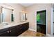Bathroom featuring double sinks with dark cabinets and marble floors at 15925 Pond Rush Ct, Land O Lakes, FL 34638