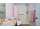 Bright bathroom featuring a walk-in shower, grab bars, and hand-held shower at 15925 Pond Rush Ct, Land O Lakes, FL 34638