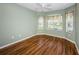 Bedroom with wood floors, ceiling fan, neutral walls, and lots of light at 15925 Pond Rush Ct, Land O Lakes, FL 34638
