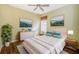 Bedroom with modern decor, beautiful paintings and natural light at 15925 Pond Rush Ct, Land O Lakes, FL 34638