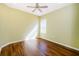 Bright bedroom features a ceiling fan, wood floors, and a window that lets in natural light at 15925 Pond Rush Ct, Land O Lakes, FL 34638