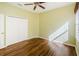 Bright bedroom with wood floors, closet, and plenty of natural light at 15925 Pond Rush Ct, Land O Lakes, FL 34638