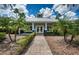 Exterior view of the community clubhouse surrounded by a manicured landscape at 15925 Pond Rush Ct, Land O Lakes, FL 34638
