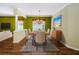 Formal dining room with modern chandelier and a view into the living area at 15925 Pond Rush Ct, Land O Lakes, FL 34638