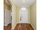 Welcoming entryway featuring wood-look floors and transom window above the front door at 15925 Pond Rush Ct, Land O Lakes, FL 34638