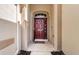 Welcoming front entrance featuring a stylish red door and manicured landscaping at 15925 Pond Rush Ct, Land O Lakes, FL 34638