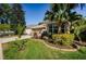 Charming home with a well-manicured lawn, a vibrant garden, and a convenient two-car garage at 15925 Pond Rush Ct, Land O Lakes, FL 34638