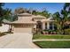 Lovely home boasting an attached two-car garage, beautiful lawn, and verdant landscaping at 15925 Pond Rush Ct, Land O Lakes, FL 34638