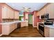 Well-equipped kitchen with stainless steel appliances, hardwood floors, and ample storage space at 15925 Pond Rush Ct, Land O Lakes, FL 34638