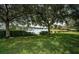 Scenic lake view featuring lush greenery, mature trees and a tranquil water scene in a beautiful community at 15925 Pond Rush Ct, Land O Lakes, FL 34638