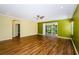 Open-concept living room with hardwood floors and sliding doors to the outdoors at 15925 Pond Rush Ct, Land O Lakes, FL 34638