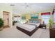 Spacious main bedroom featuring plush carpet, tray ceiling, and attached bathroom with shower at 15925 Pond Rush Ct, Land O Lakes, FL 34638