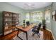 Home office features built in shelves, large windows, and hardwood flooring at 15925 Pond Rush Ct, Land O Lakes, FL 34638