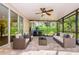 Screened-in patio with ceiling fan and outdoor furniture for relaxing at 15925 Pond Rush Ct, Land O Lakes, FL 34638