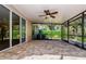 Spacious screened-in patio with brick flooring and a ceiling fan offers outdoor living at 15925 Pond Rush Ct, Land O Lakes, FL 34638