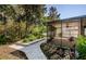 A screened patio is accessible via a stone path through the backyard garden at 15925 Pond Rush Ct, Land O Lakes, FL 34638