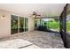 Spacious screened-in patio with brick flooring and a ceiling fan offers outdoor living at 15925 Pond Rush Ct, Land O Lakes, FL 34638