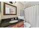 Bathroom showcasing a vanity with granite countertops, framed mirror, toilet and a shower at 16064 Dawnview Dr, Tampa, FL 33624