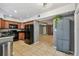 Kitchen featuring black appliances, wood cabinets, tile floor and open floor plan at 16064 Dawnview Dr, Tampa, FL 33624
