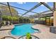 Backyard with a screened-in pool and brick paver decking at 16064 Dawnview Dr, Tampa, FL 33624