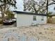 Rear exterior view of the house, featuring a plain yard and part of the driveway at 1731 W Perio St, Tampa, FL 33612