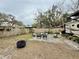 Backyard with outdoor seating, fire pit, an RV, and a wooden fence offering a cozy outdoor living space at 1731 W Perio St, Tampa, FL 33612