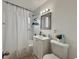 Clean bathroom featuring a vanity, toilet, and a shower with white tile walls at 1731 W Perio St, Tampa, FL 33612