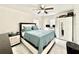Bright bedroom features a ceiling fan, modern wardrobe, and sleek white tile floors, creating a comfortable space at 1731 W Perio St, Tampa, FL 33612