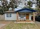 Charming single story home featuring a cozy porch with rocking chairs and blue accents at 1731 W Perio St, Tampa, FL 33612