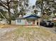 Charming single story home featuring a cozy porch with rocking chairs and blue accents at 1731 W Perio St, Tampa, FL 33612