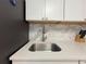 Close-up view of the kitchen sink with stainless steel faucet and light countertops at 1731 W Perio St, Tampa, FL 33612