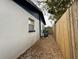 Side yard features a secure wood fence, providing privacy and delineating the property line at 1731 W Perio St, Tampa, FL 33612