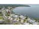 Stunning aerial view of waterfront homes with private docks and lush landscaping on a sunny day at 200 Driftwood W Dr, Palm Harbor, FL 34683
