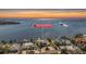 Stunning aerial view of waterfront home showcasing beautiful landscaping, a private dock, and serene water views at 200 Driftwood W Dr, Palm Harbor, FL 34683