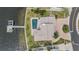 Overhead aerial of waterfront property with a boat dock, beautiful pool, and brick paver driveway at 200 Driftwood W Dr, Palm Harbor, FL 34683